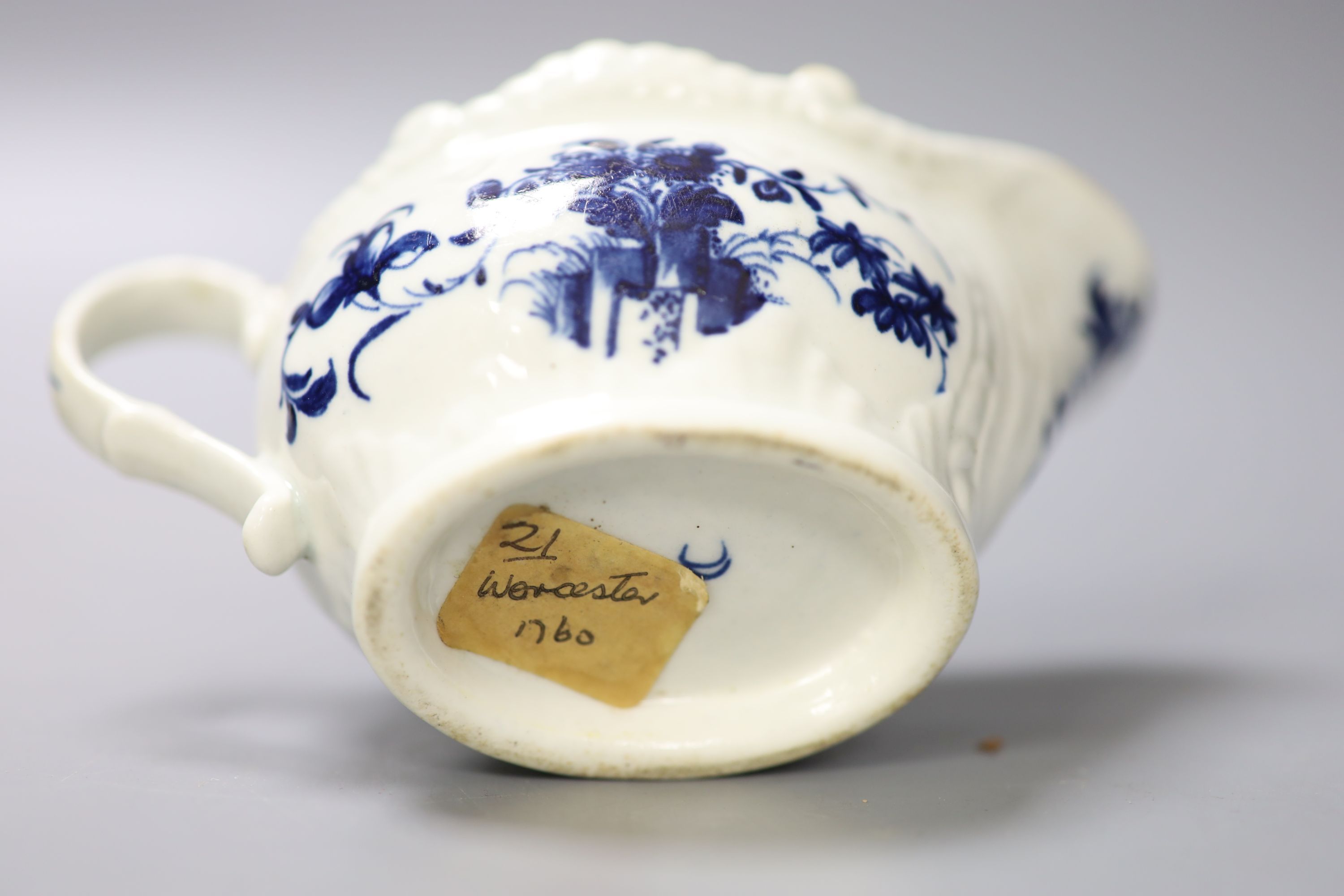 A Worcester small sauceboat painted with Two Porter Landscape in moulded panel, flowers verso, c.1760